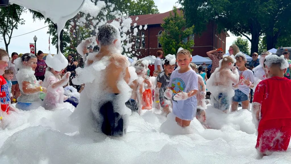 Kids playing in a giant pile of party foam