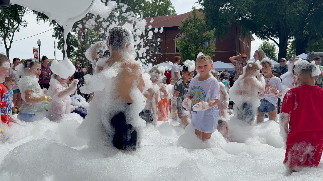 Kids playing in a giant pile of party foam